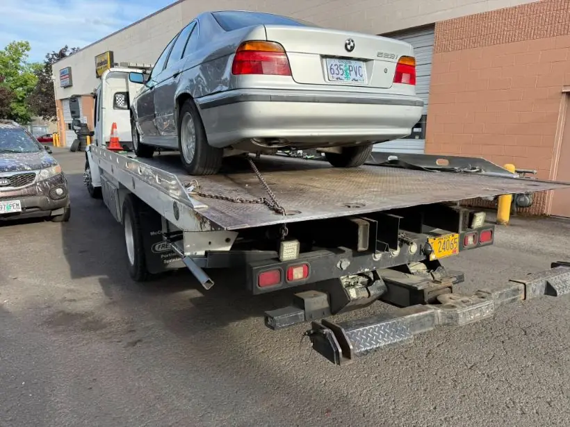 Silver BMW on a Zee's Towing flatbed in Portland