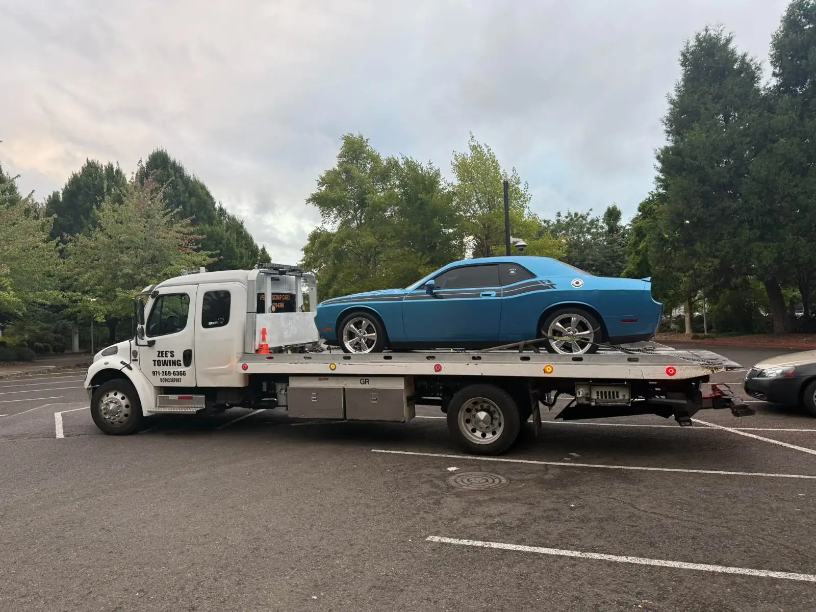 Zee's Towing flatbed truck loading a car in Portland