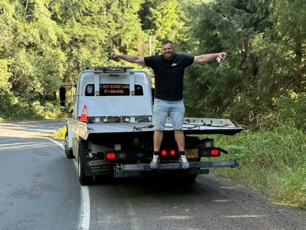 Zee's Towing owner-operator on a flatbed tow truck near Portland